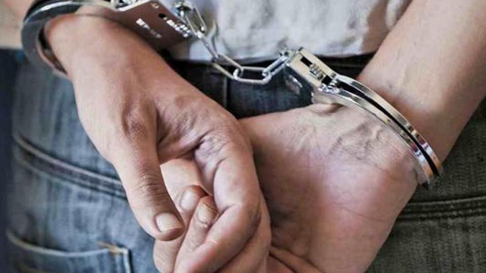 hands bound by Handcuffs.