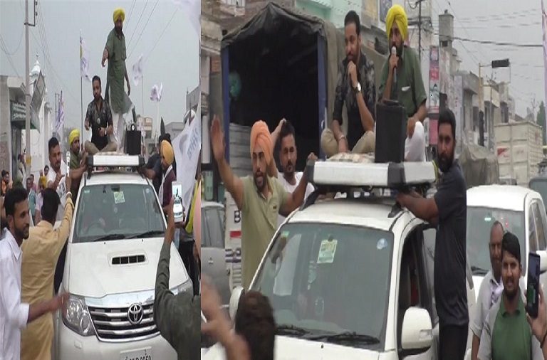 AAP’s Bhagwant Mann does Bhangra, throws flowers at protestors waving black flag during his roadshow