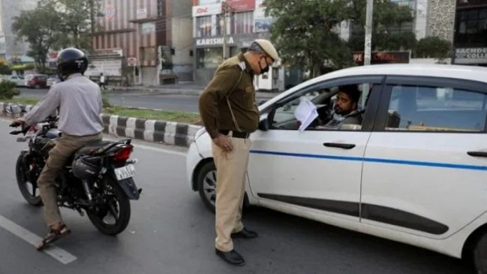 Car passenger shows Lockdown Pass to cop- File Photo