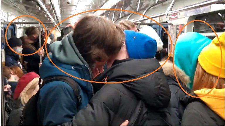 Russian couples protest against COVID-19 restrictions by kissing in packed trains