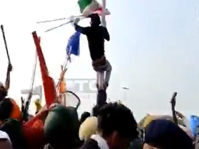 Man Throws National Flag away, places Sikh flag on top of flagpole