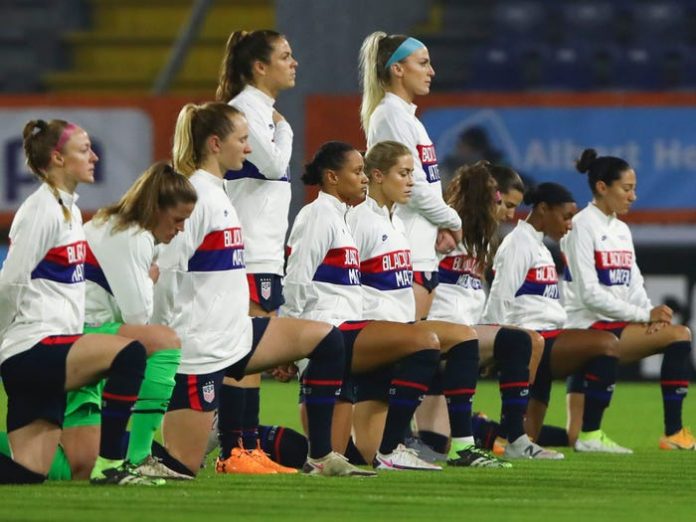 US women's soccer team takes a knee during its inaugural match with Sweden at the Tokyo Olympics
