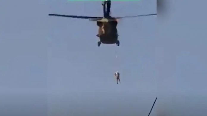 Shocking visuals show Taliban flying a US Black Hawk helicopter with a body hanging from it