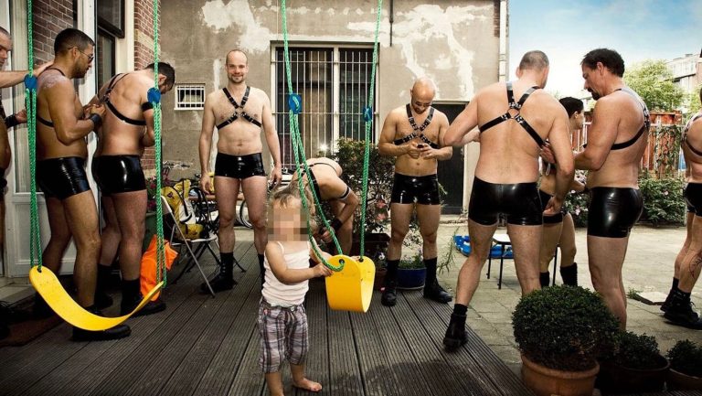 Image of a girl child surrounded by men in bondage sex costume wins award at Dutch Pride event