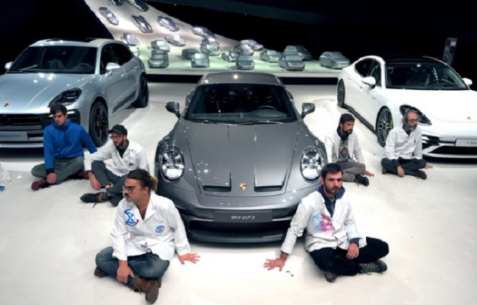 German-based activists glue themselves to Volkswagen’s Autostadt floor to protest against climate change