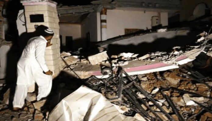 An individual surveying the earthquake's damage.