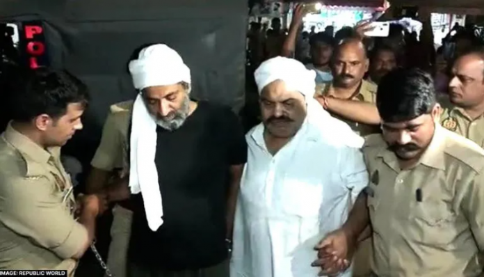 Atiq Ahmed (in white kurta) and Ashraf Ahmed (in black kurta) going to hospital, moments before their deaths.