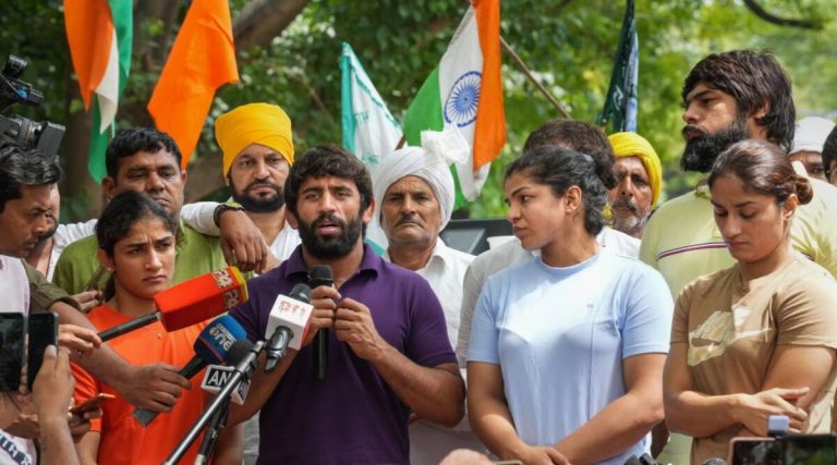 Security personnel detain protesting wrestlers during their march towards new Parliament building