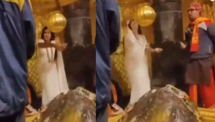 Woman showered money on Kedarnath Shivling.