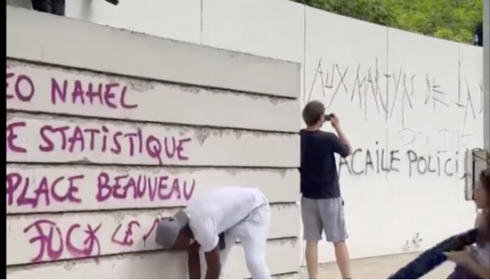 A memorial to those deported from France during the Holocaust and World War II is defaced during violence.