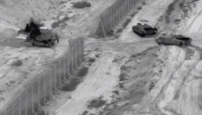 Israeli armoured vehicles participate in an operation at a location given as the northern Gaza Strip.