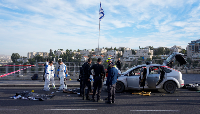 Cops and rescue workers at the scene of a terror shooting attack in Jerusalem.