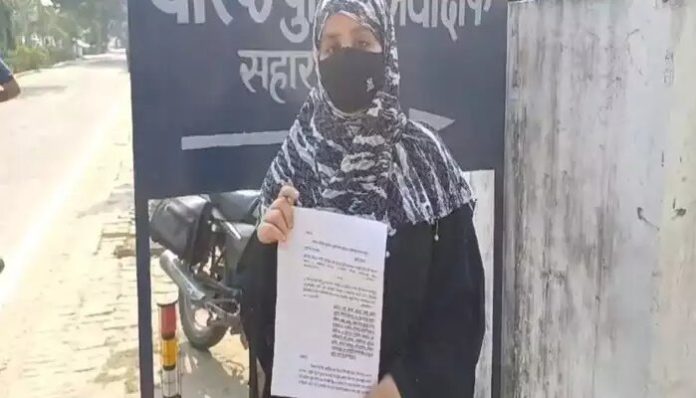 The victim with her request letter at the SSP office in Saharanpur.
