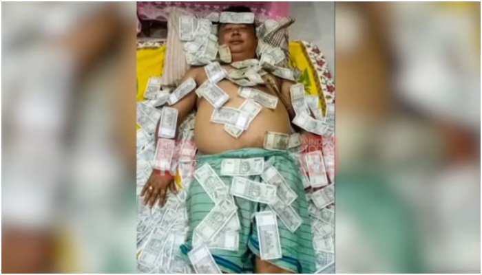 Assam: Politician lying on a bed of Rs 500 notes, pic goes viral