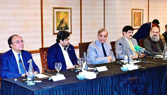Prime Minister Shehbaz Sharif addresses businessmen in Karachi.