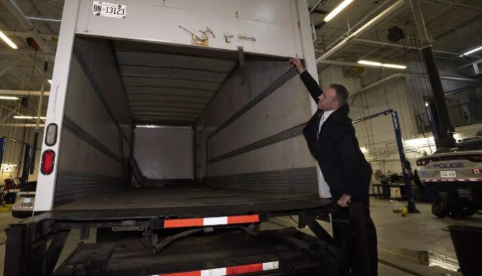 Police show a recovered truck to the media.