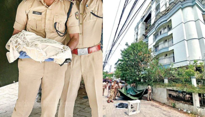 Police officials with the bag containing the mortal remains of the child.