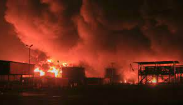 Oil tanks burn at the port in Hodeidah following Israel's attack.