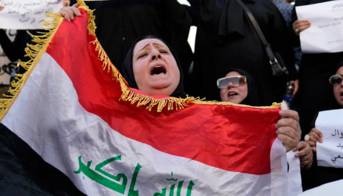 Iraqi women protest at Tahrir Square, in Baghdad.