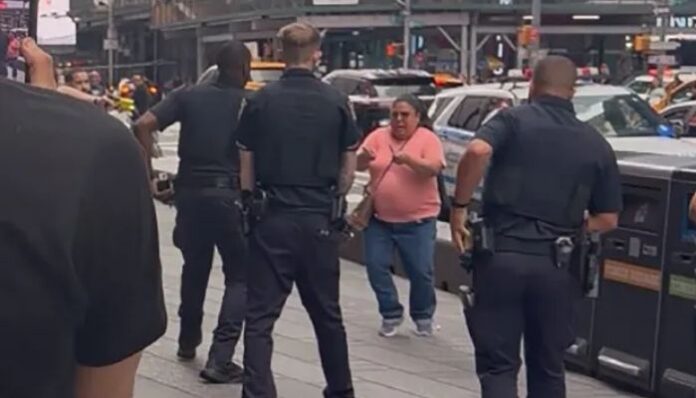A woman armed with two knives stabbed two people in crowded Times Square in New York on Monday, killing a 32-year-old woman and injuring a 68-year-old man.